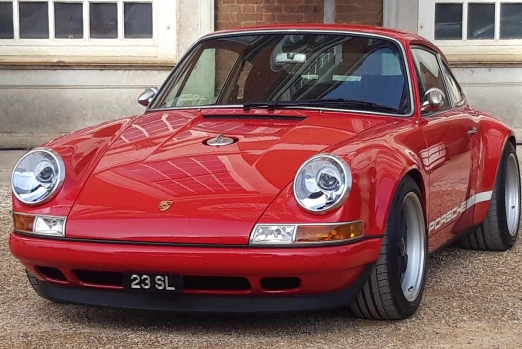 A luxurious Singer Porsche, showcasing a sleek and timeless design with classic Porsche styling enhanced by modern, high-performance upgrades. The car features a glossy finish, elegant curves, and high-end detailing, embodying a perfect blend of vintage charm and cutting-edge automotive engineering.