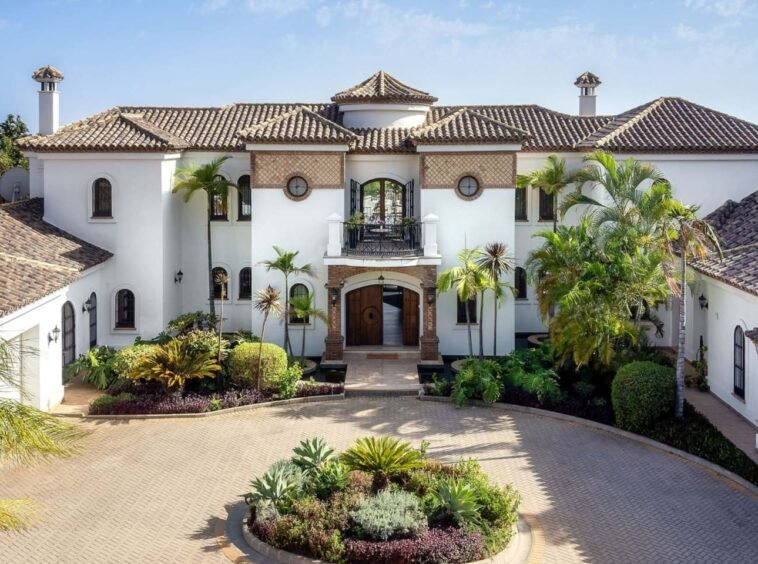 Stunning facade of an authentic Andalusian villa with breathtaking sea views, showcasing traditional architectural elements such as terracotta tiles, ornate detailing, and arched windows, blending timeless Andalusian charm with panoramic views of the ocean.
