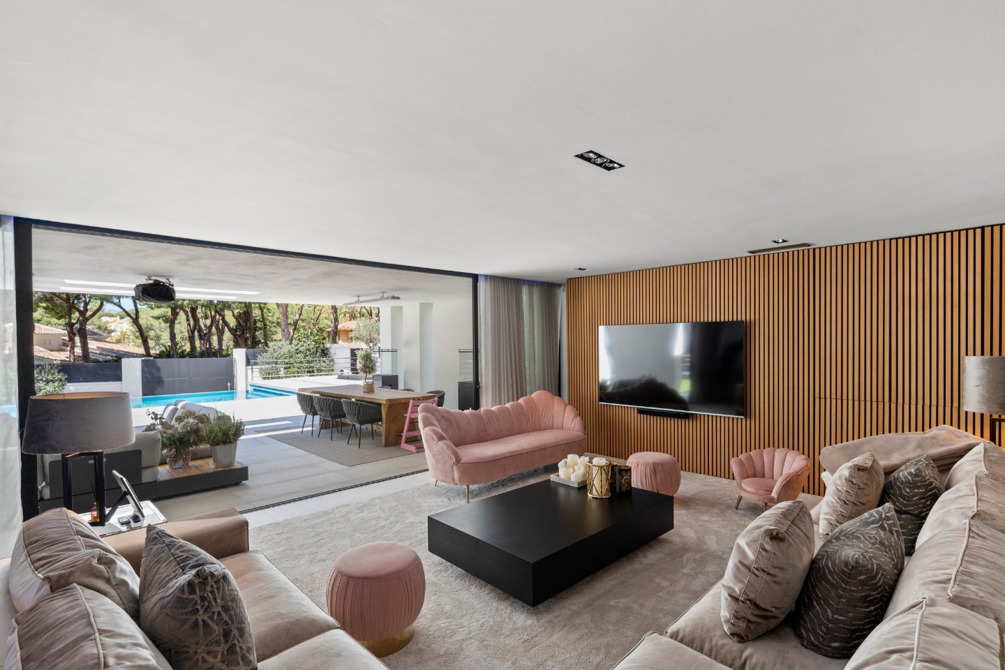 Sophisticated bedroom in an elegant villa in Marbella East, featuring modern furnishings, large windows with views of lush greenery, and a serene, spacious design that combines luxury and comfort for a peaceful retreat.