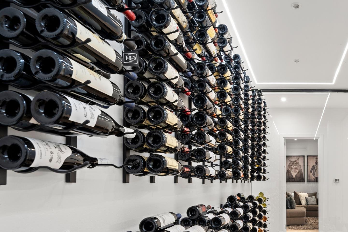 Exquisite wine cellar in an elegant villa in Marbella East, featuring rows of climate-controlled shelving, ambient lighting, and a sophisticated design that creates a refined atmosphere for storing and displaying an impressive wine collection.