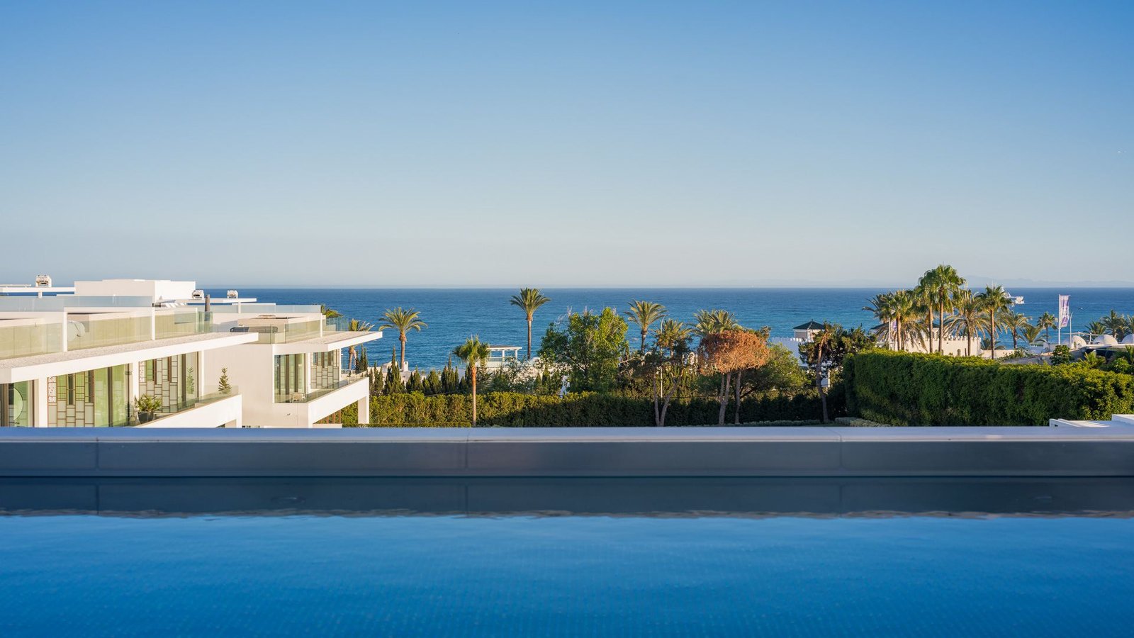 Stunning infinity pool in an exclusive residence near Puente Romano, Marbella Golden Mile, offering panoramic views of the surrounding landscape. The sleek design of the pool seamlessly blends with the horizon, creating a luxurious and serene space for relaxation and enjoyment.
