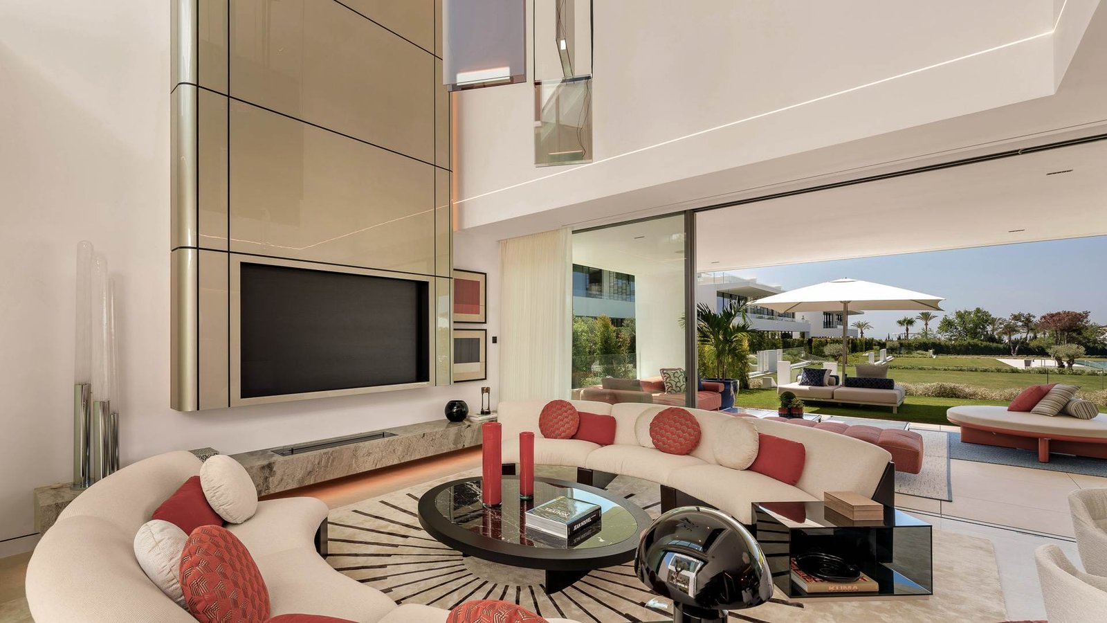 Sophisticated TV lounge in a luxury residence near Puente Romano on the Golden Mile, featuring plush contemporary seating, warm ambient lighting, and a sleek built-in entertainment unit. The space is designed for comfort and relaxation, with neutral tones, elegant décor, and a seamless blend of modern luxury and cozy ambiance.