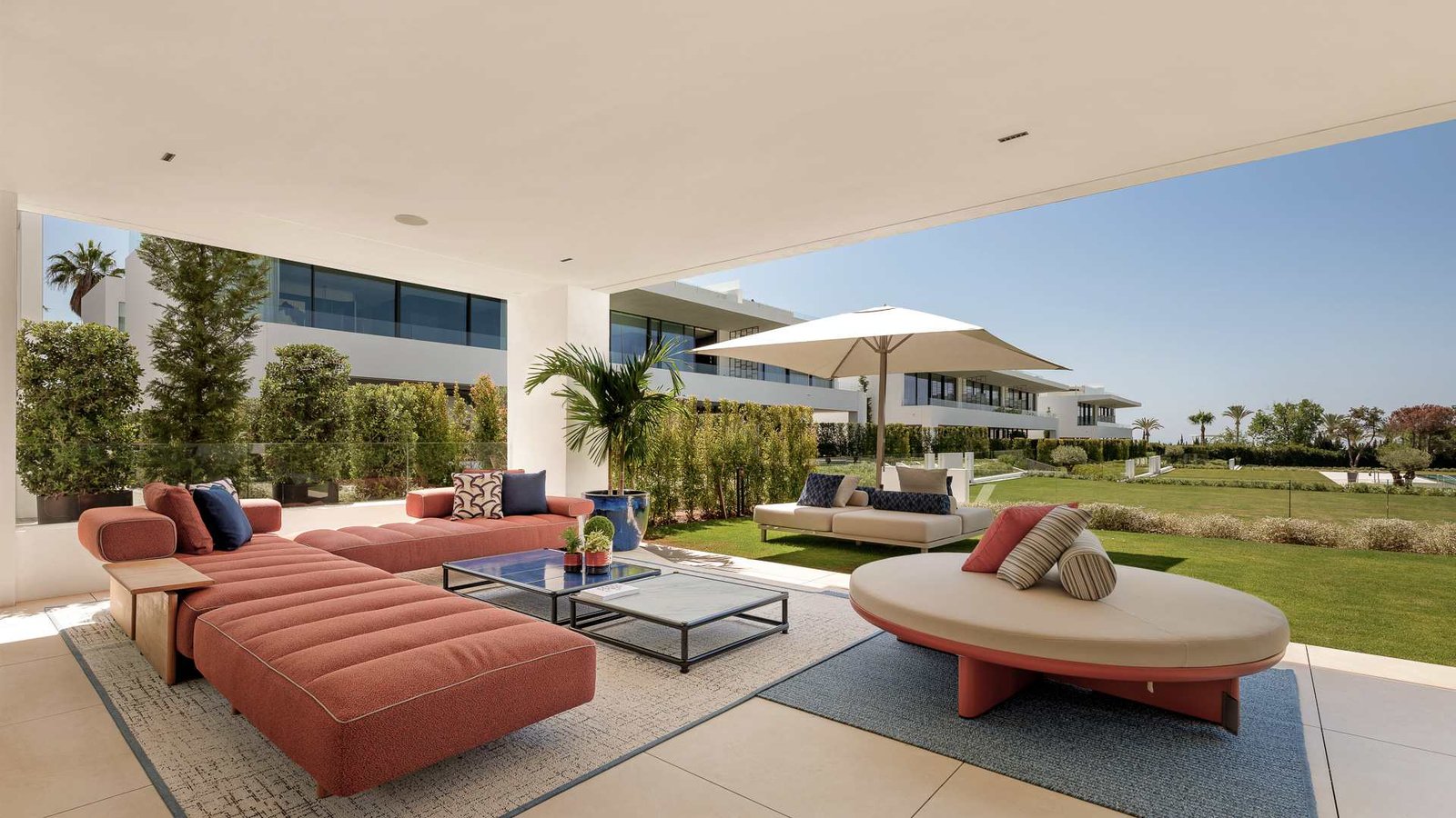 Expansive terrace and lush gardens of a luxury residence near Puente Romano on the Golden Mile, featuring elegant outdoor seating, manicured greenery, and ambient lighting. The stylish open-air space offers a seamless blend of modern comfort and natural beauty, perfect for relaxation and entertaining in an exclusive setting.