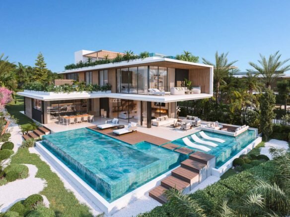 A luxurious modern villa in Cascada de Camoján with a sleek white facade, expansive glass windows, and elegant outdoor lighting. The property is surrounded by lush greenery and palm trees, creating a serene and upscale atmosphere.