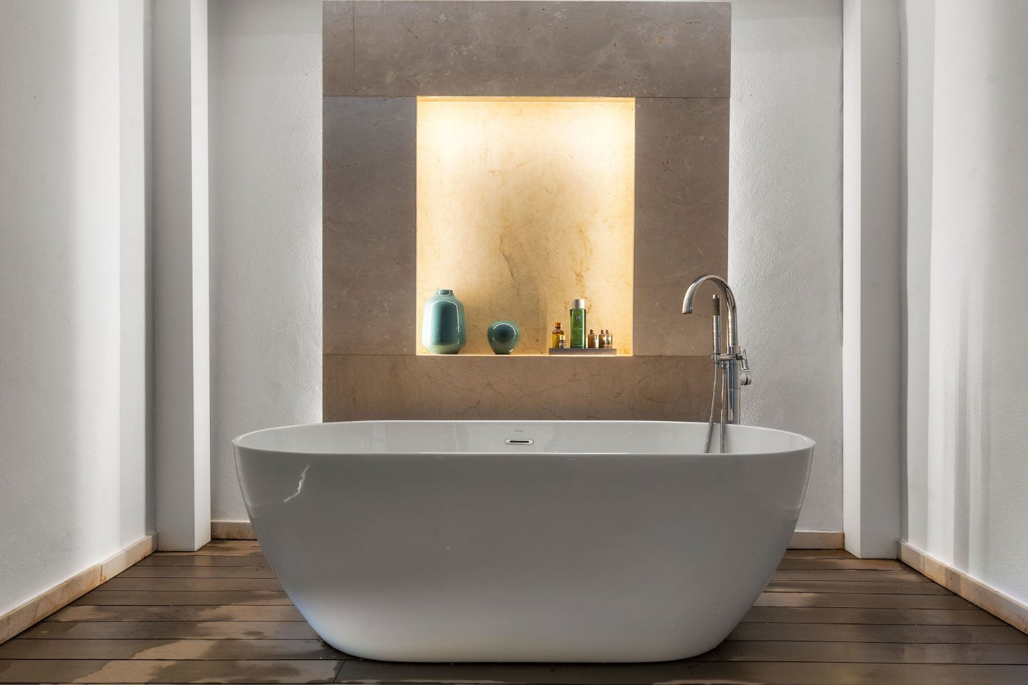 A spacious and elegant bathroom featuring a freestanding bathtub, a large walk-in shower with glass walls, and luxurious marble finishes. Natural light pours in through expansive windows, offering serene views of the golf course and enhancing the spa-like atmosphere of the space.