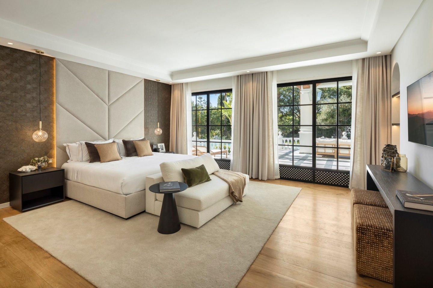 Luxurious bedroom in a majestic Andalusian palace in Marbella, featuring opulent furnishings, intricate design details, and large windows that allow natural light to flood the space, creating a serene and elegant retreat with timeless charm.