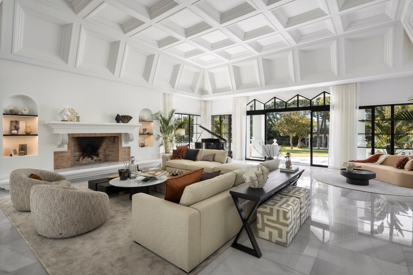 Stunning living room in a majestic Andalusian palace in Marbella, featuring intricate architectural details, grand furnishings, and large windows that flood the space with natural light, creating an elegant and timeless atmosphere for luxury living.