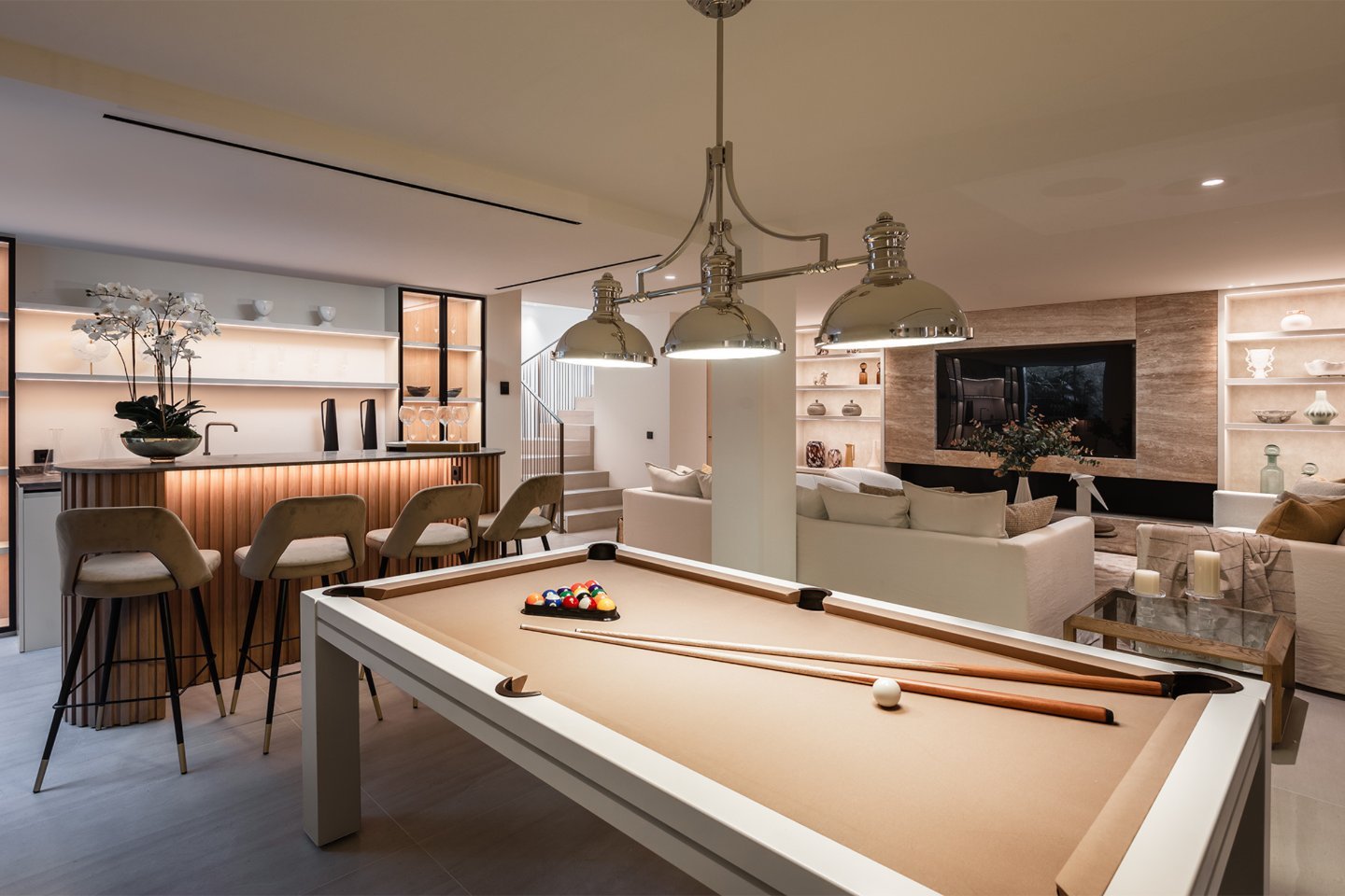Stylish games room and bar in a modern villa in Nueva Andalucía, featuring a sleek pool table, contemporary furnishings, and a well-equipped bar area. The space is designed for both relaxation and entertainment, with ambient lighting and a sophisticated, yet fun atmosphere, perfect for hosting guests or enjoying leisure time in luxury.