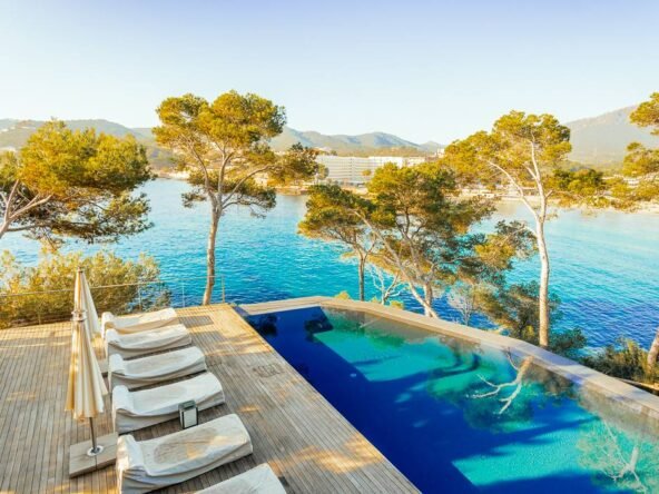 Breathtaking view from a seafront luxury villa in Camp de Mar, Mallorca, showcasing a stunning terrace that extends over the sea, with panoramic ocean views and a perfect blend of natural beauty and modern architecture.