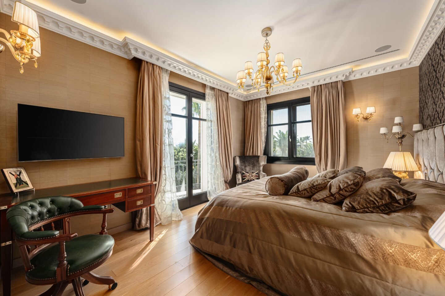 Sophisticated bedroom in a luxury villa in Las Chapas, Marbella, featuring elegant furnishings, soft neutral tones, and large windows that offer plenty of natural light. The room combines timeless design with modern comfort, creating a serene and inviting atmosphere perfect for relaxation and rest.